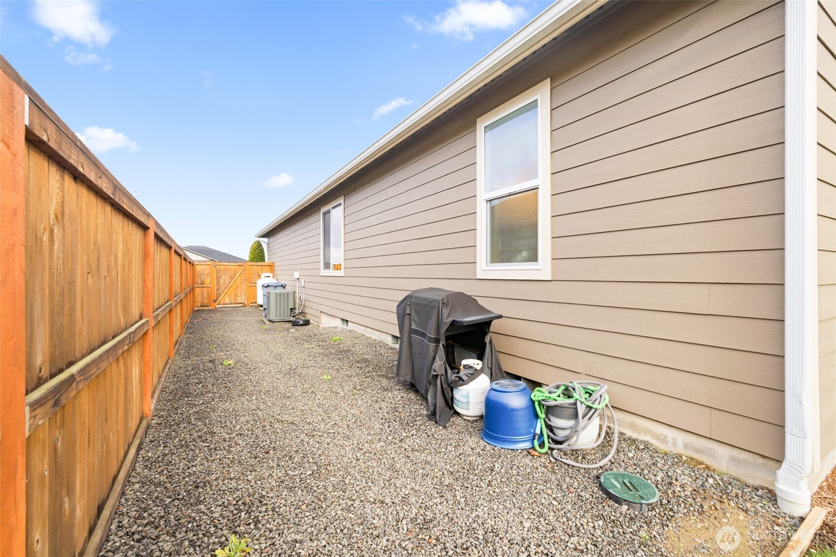 440 Blue Glacier Loop Sequim, WA 98382 - Photo 28 of 34 a view of a porch with wooden stairs and a potted plant