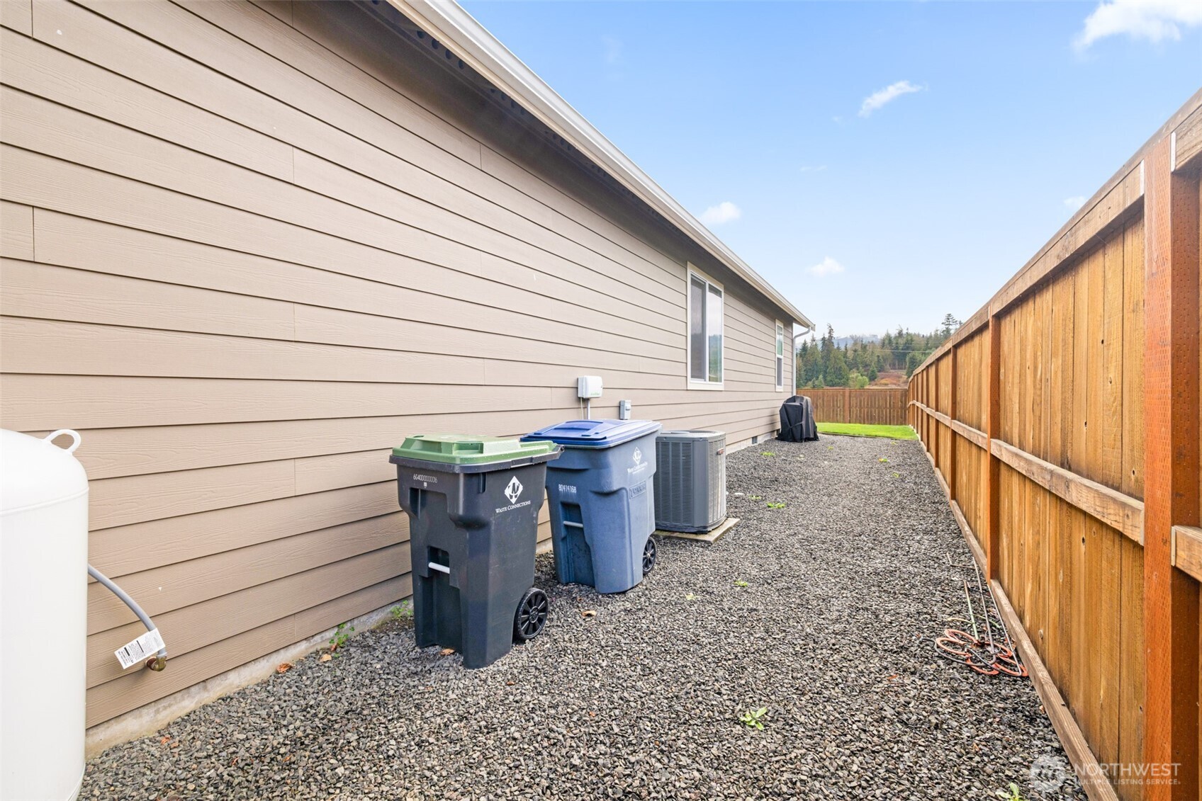 440 Blue Glacier Loop Sequim, WA 98382 - Photo 29 of 34 a view of a patio with wooden wall and floor to ceiling window