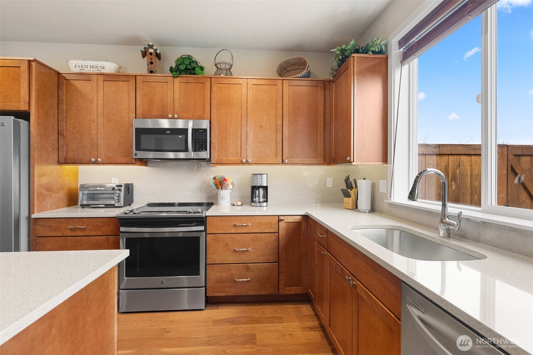440 Blue Glacier Loop Sequim, WA 98382 - Photo 6 of 34 a kitchen with stainless steel appliances granite countertop a sink stove and microwave