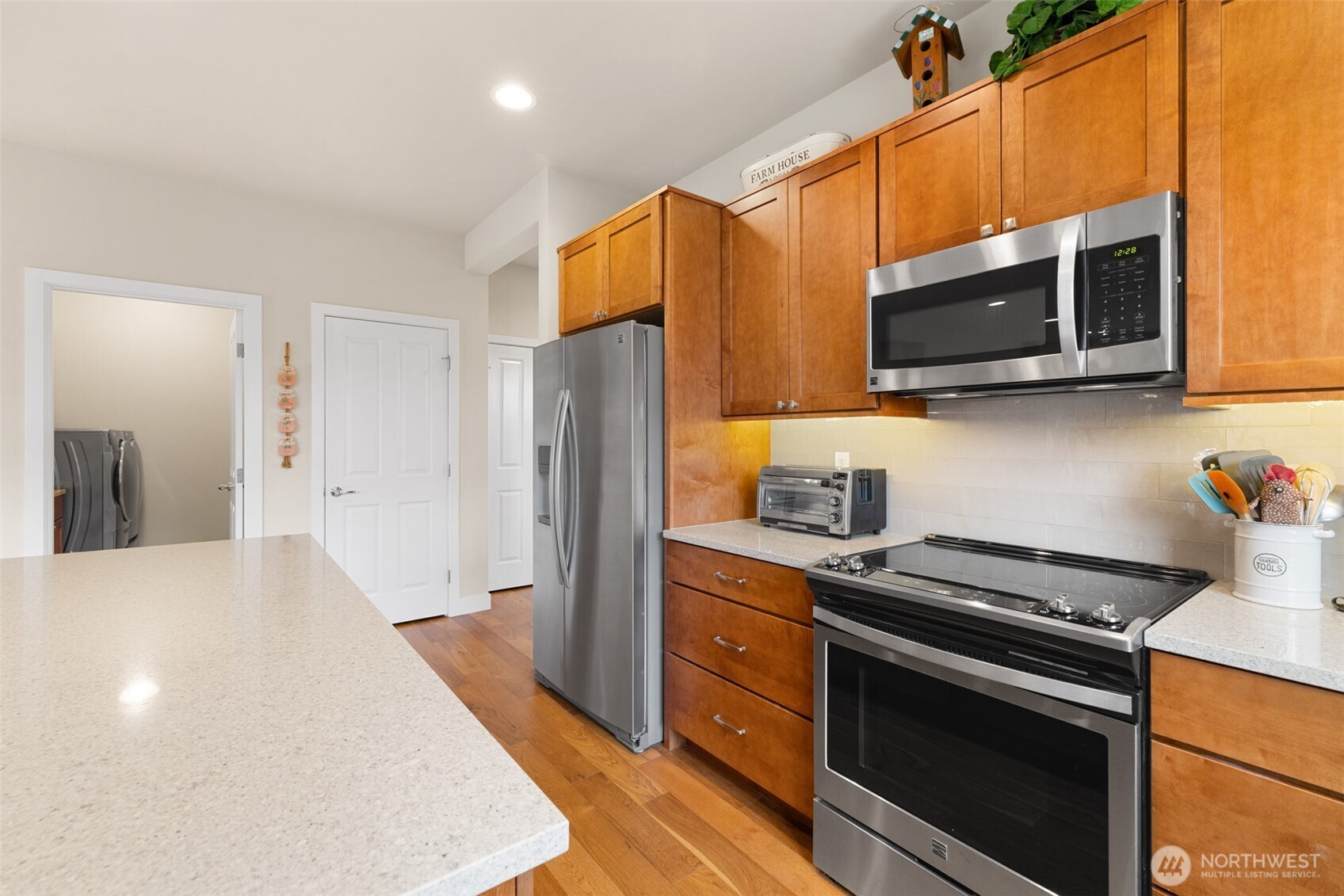 440 Blue Glacier Loop Sequim, WA 98382 - Photo 7 of 34 a kitchen with stainless steel appliances a stove microwave and refrigerator