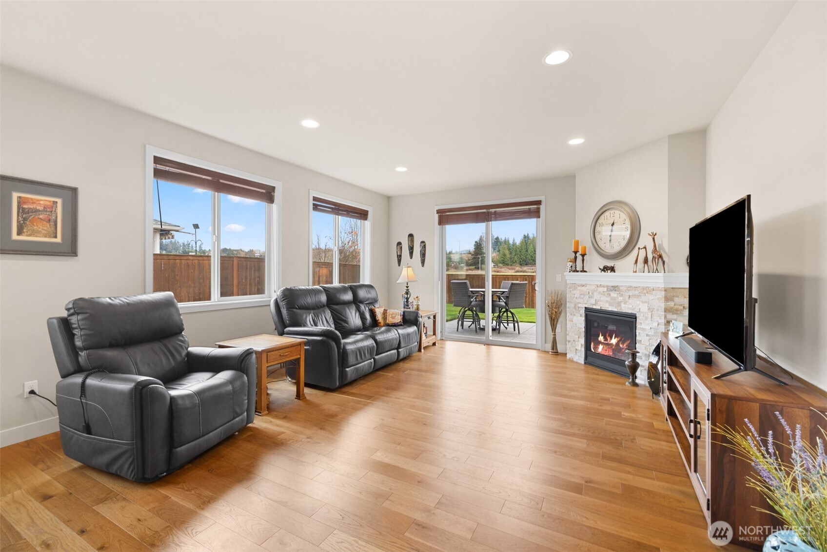 440 Blue Glacier Loop Sequim, WA 98382 - Photo 10 of 34 a living room with fireplace furniture flat screen tv and wooden floor
