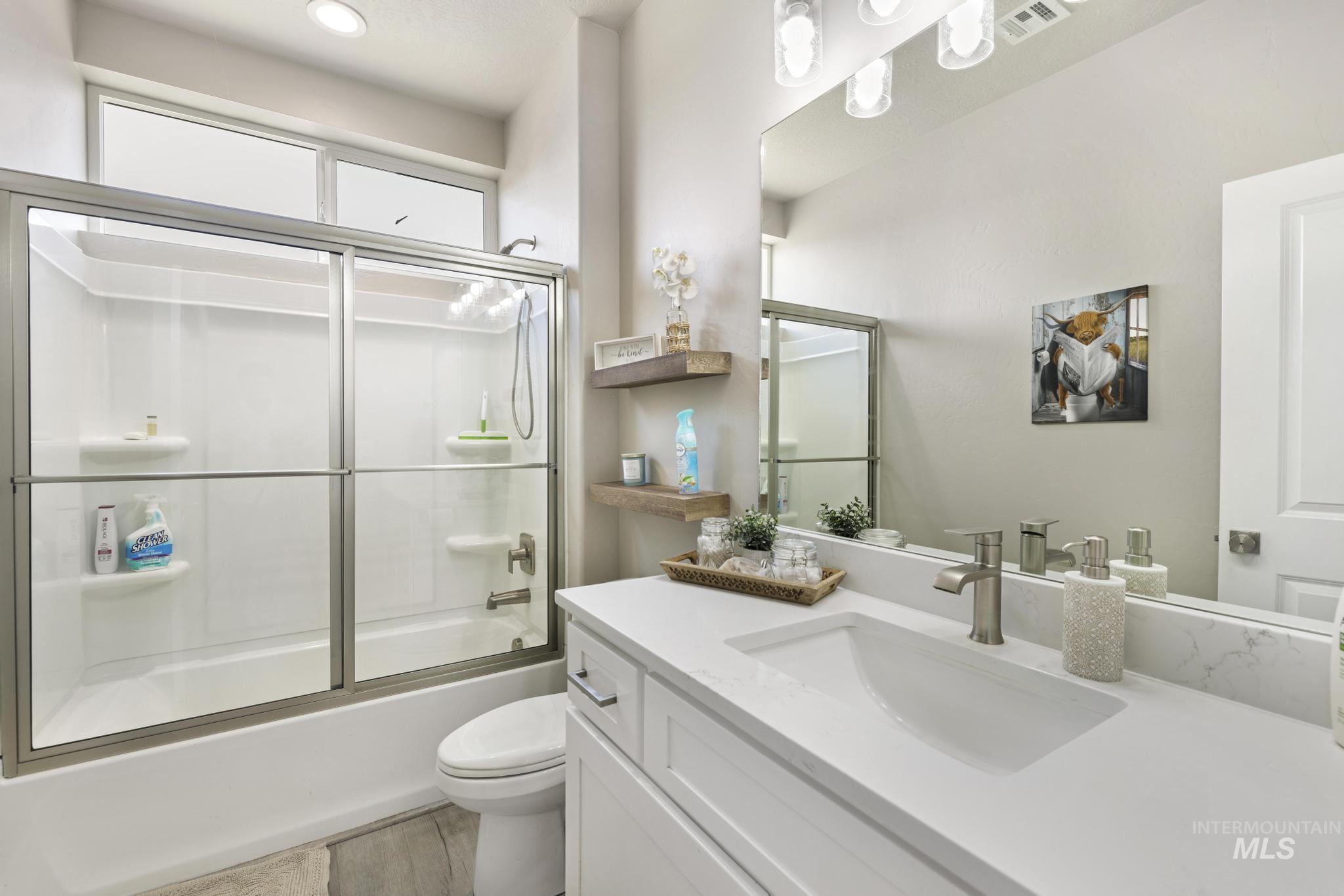 758 Cedar Crk Road Rogerson, ID 83302 - Photo 17 of 50 Contemporary bathroom featuring a tub-shower combination with a sliding glass enclosure