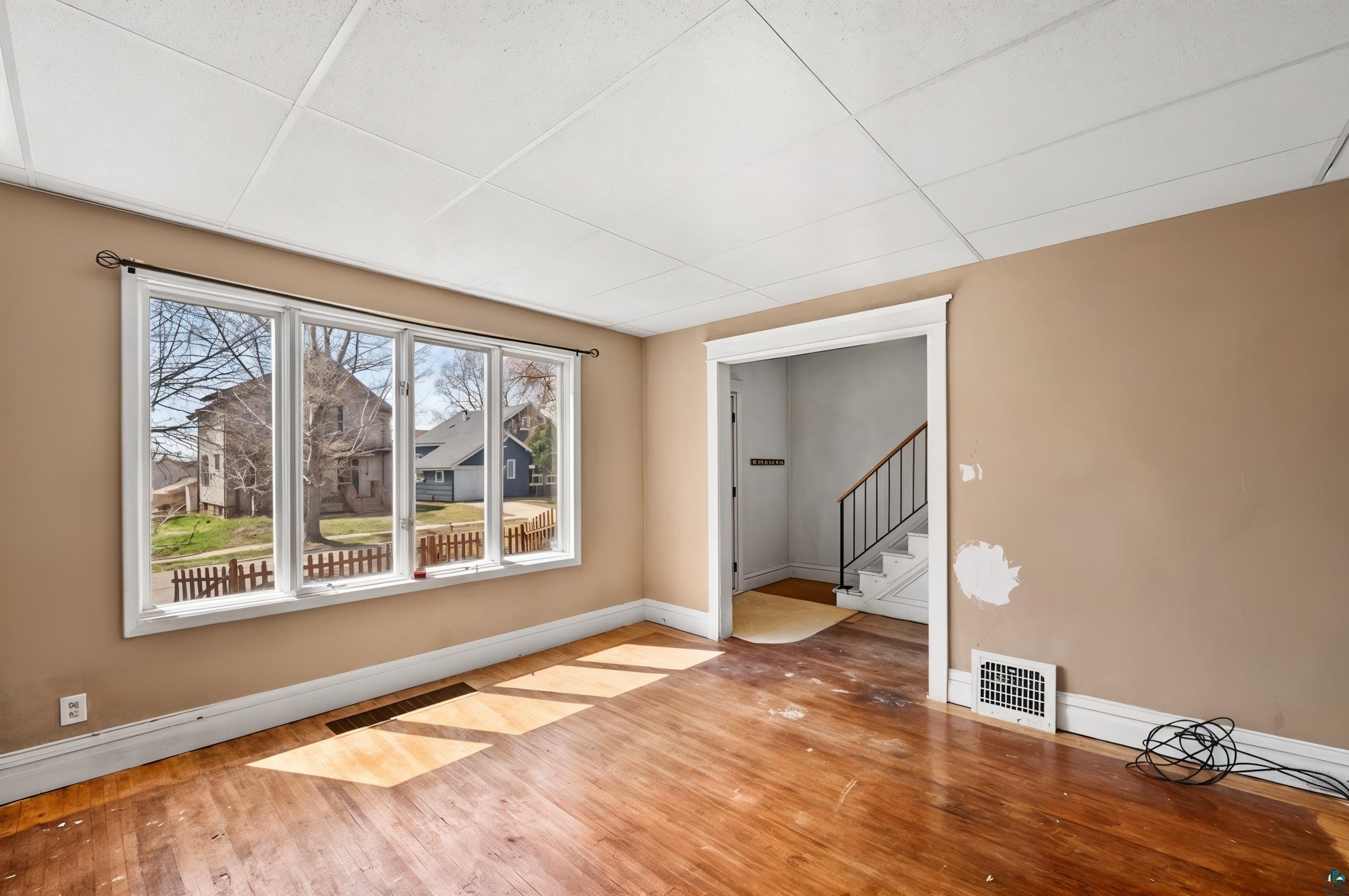 3067 Restormel Street Duluth, MN 55806 - Photo 3 of 25 Spacious interior featuring a multi-pane window, wood-finish flooring, and neutral wall tones