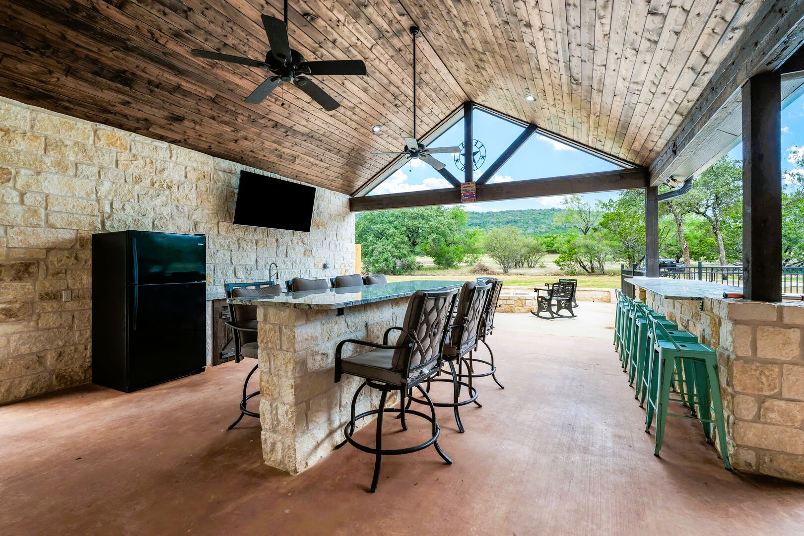 1718 Mountain Valley Road Concan, TX 78838 - Photo 30 of 40 Stone accent walls and a rich wood ceiling define this expansive covered outdoor living area.