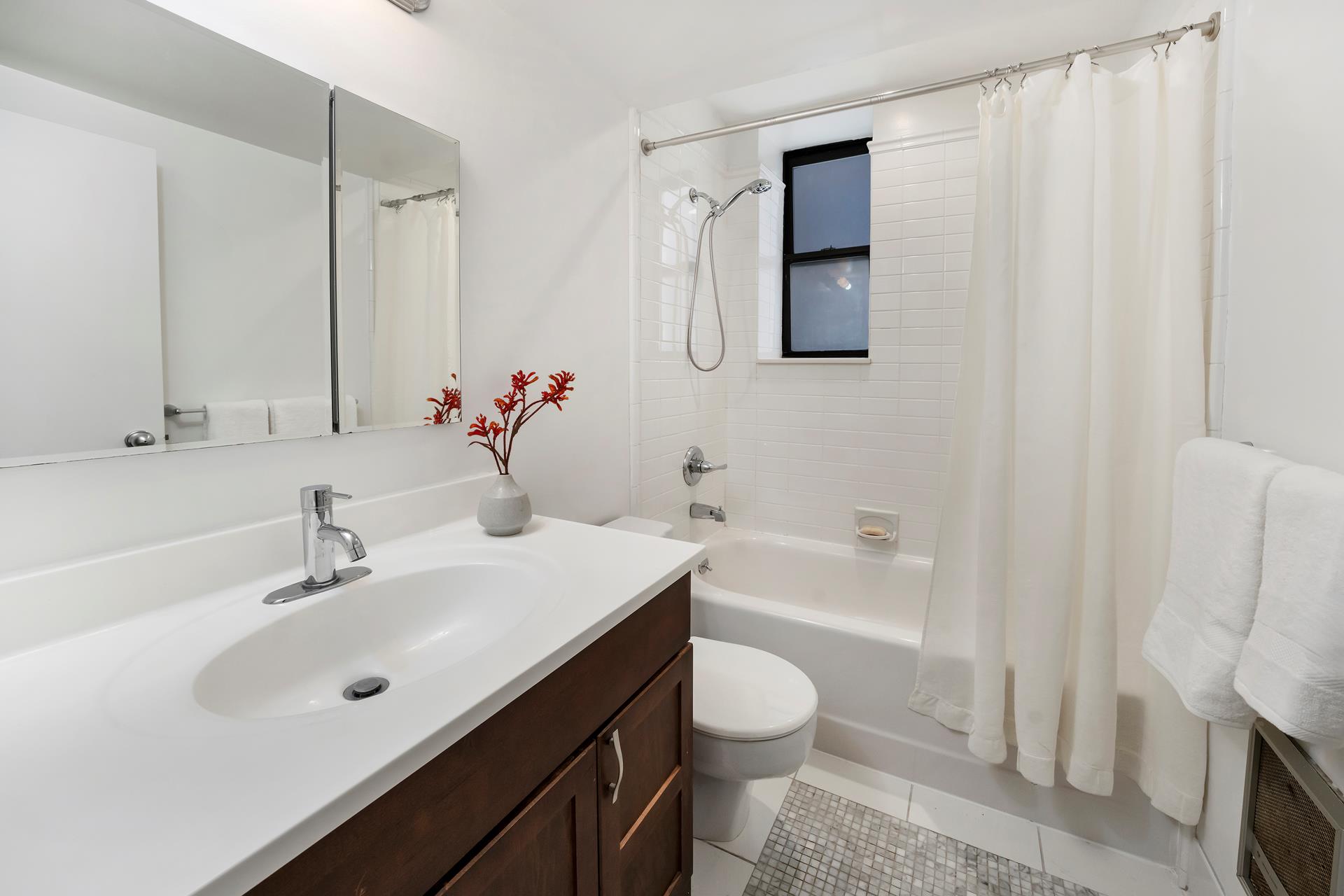 314 West 94th Street, Unit 2A Manhattan, NY 10025 - Photo 8 of 10 a bathroom with a sink a toilet and bathtub