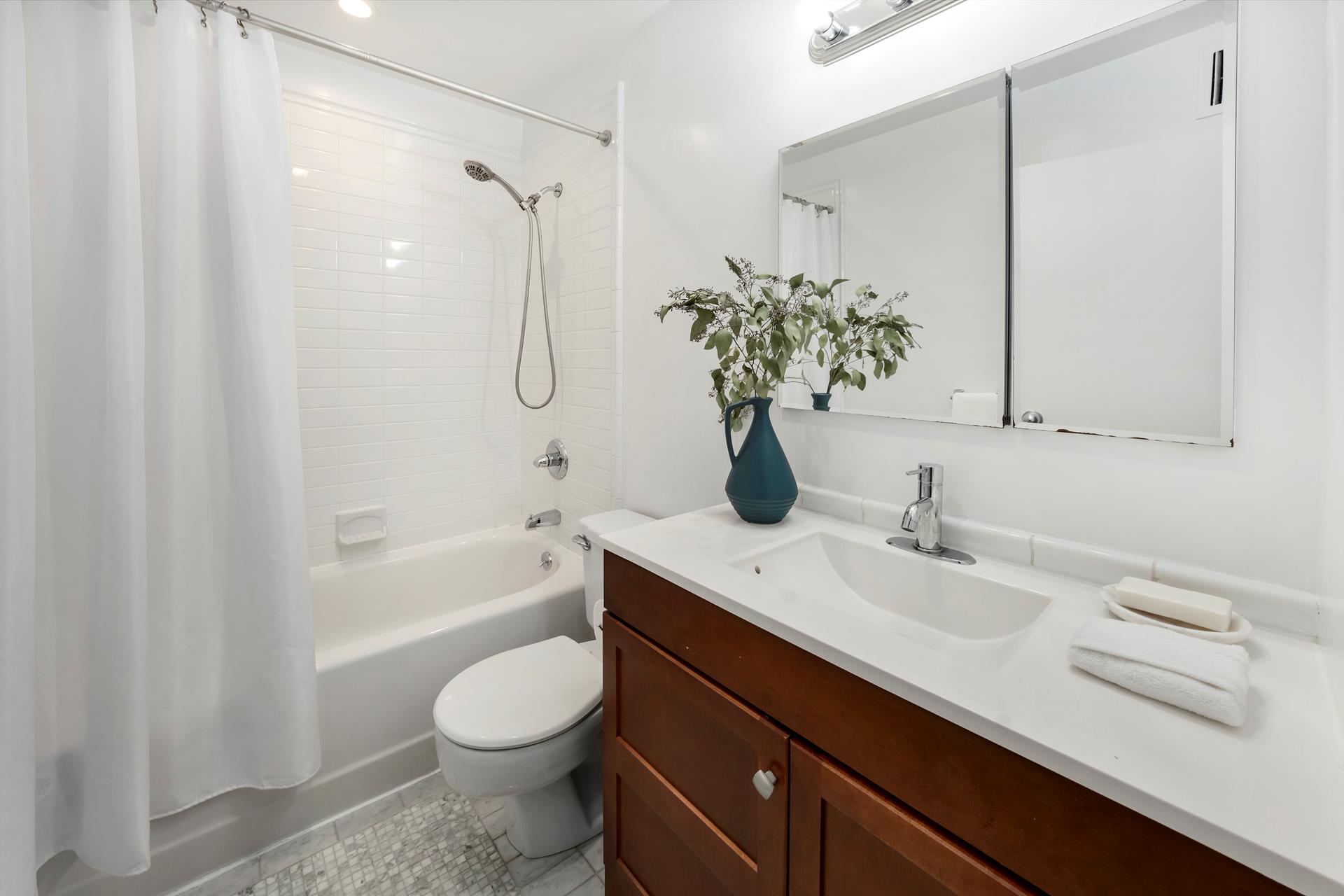 314 West 94th Street, Unit 2A Manhattan, NY 10025 - Photo 9 of 10 a bathroom with a granite countertop sink toilet and shower
