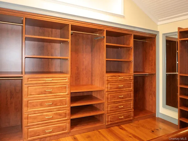 a view of a room with wooden floor and window