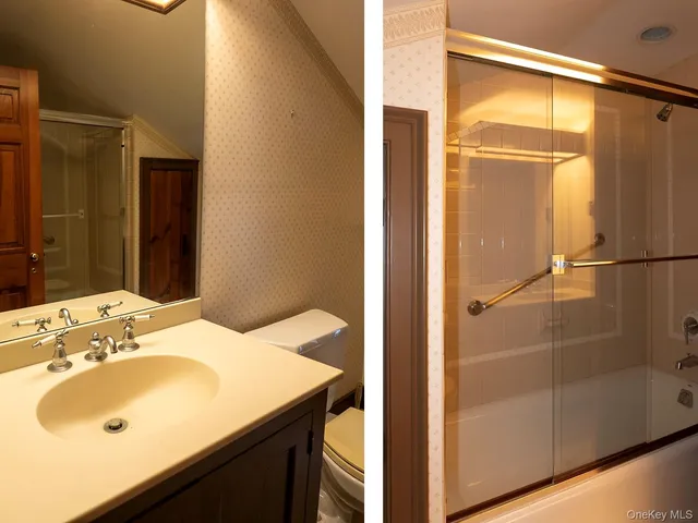 a view of a white house with a big yard and large trees