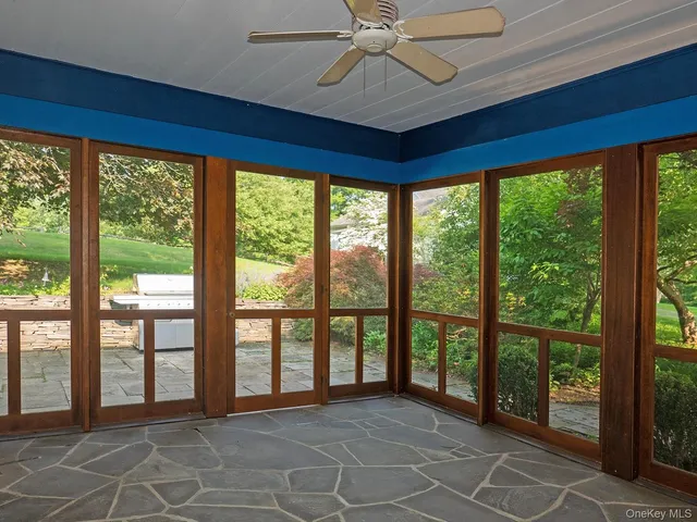 a front view of a house with a yard and green space