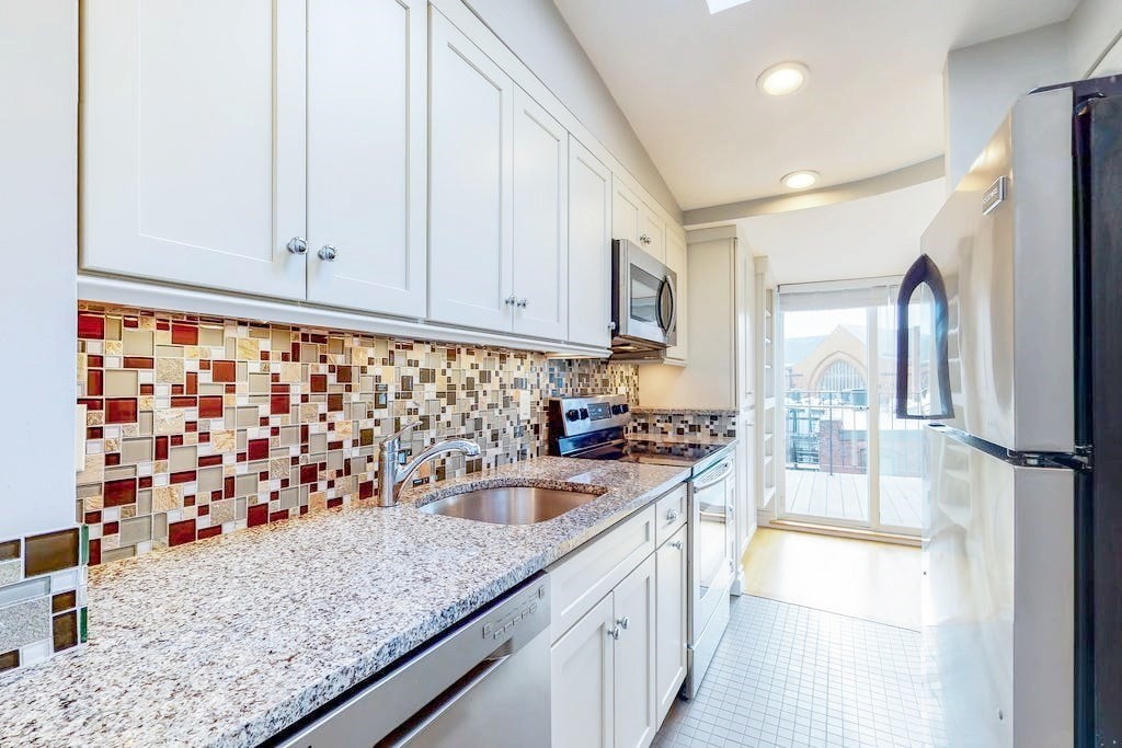 16 Symphony Road, Unit 5 Boston, MA 02115 - Photo 11 of 36 a kitchen with granite countertop a sink and a refrigerator