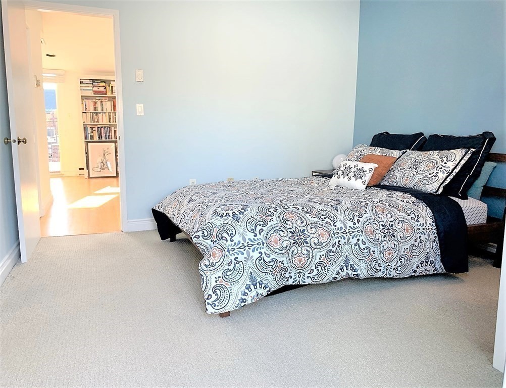16 Symphony Road, Unit 5 Boston, MA 02115 - Photo 17 of 36 a bed sitting in a bedroom next to a window