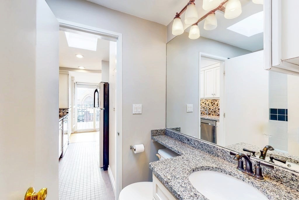 16 Symphony Road, Unit 5 Boston, MA 02115 - Photo 27 of 36 a bathroom with a granite countertop double vanity sink mirror and toilet