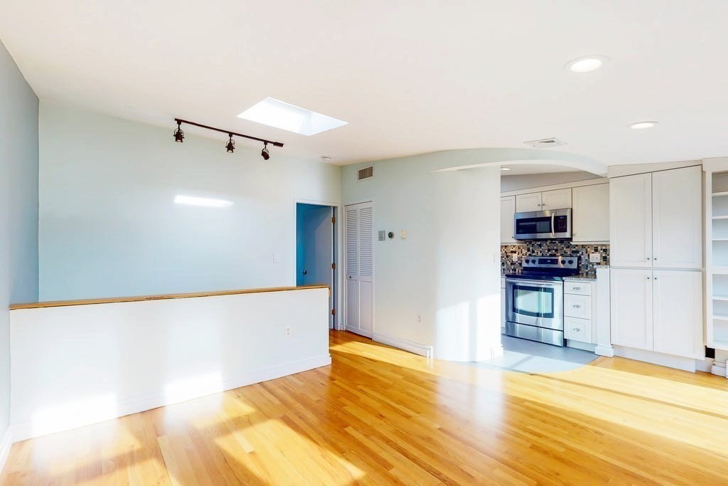 16 Symphony Road, Unit 5 Boston, MA 02115 - Photo 5 of 36 a view of a kitchen with a sink and a refrigerator