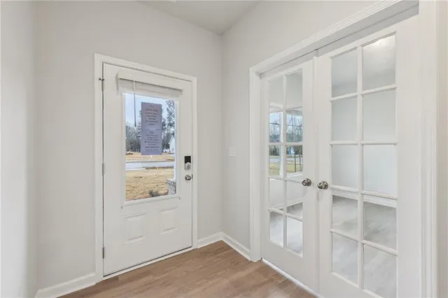 a view of an entryway with wooden floor