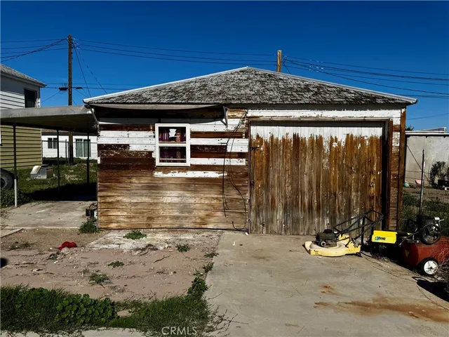 a view of a house with backyard porch and sitting area