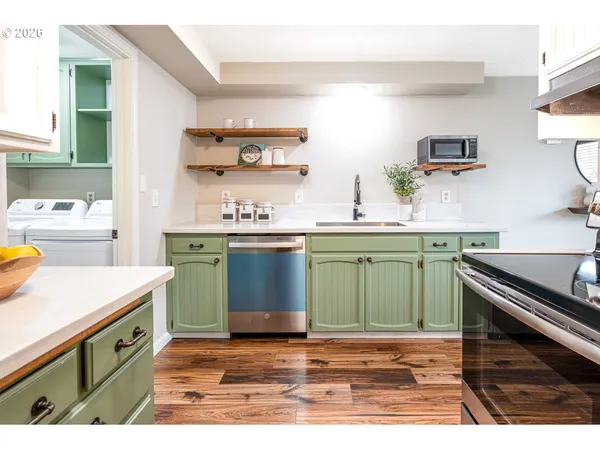 a kitchen with a sink and a stove top oven