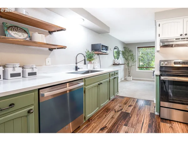 a kitchen with a sink stove top oven and cabinets