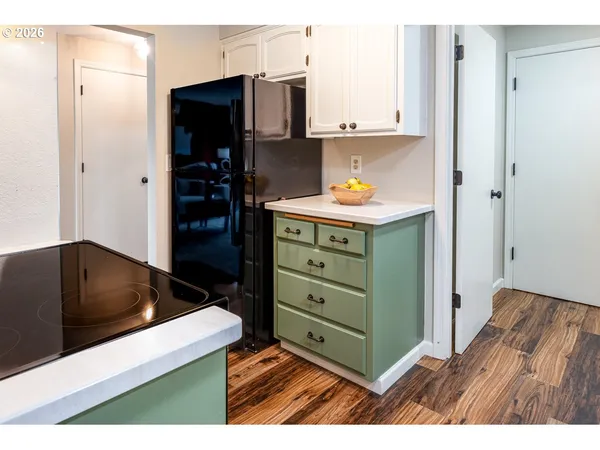 a kitchen with cabinets and a refrigerator
