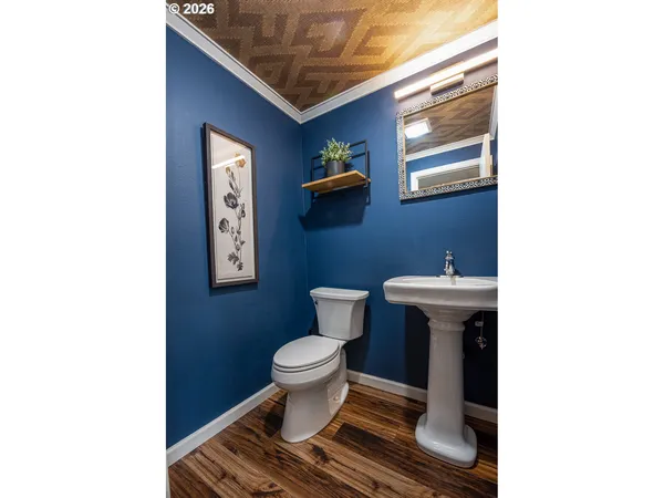 a bathroom with a toilet and a mirror