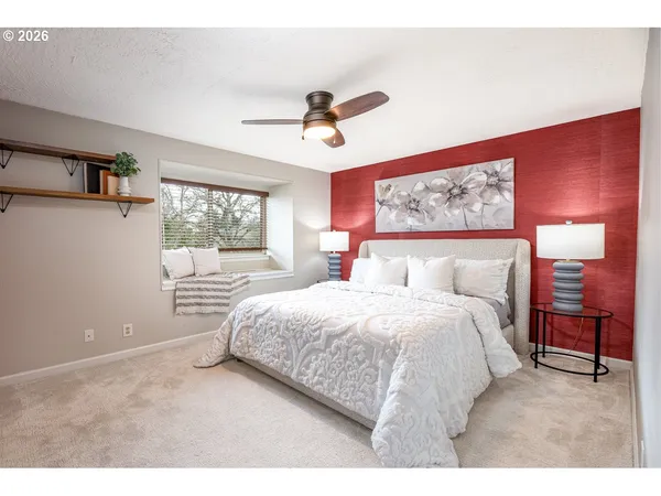a bedroom with a large bed and a window