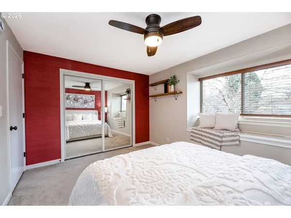 a bedroom with a bed and a large window