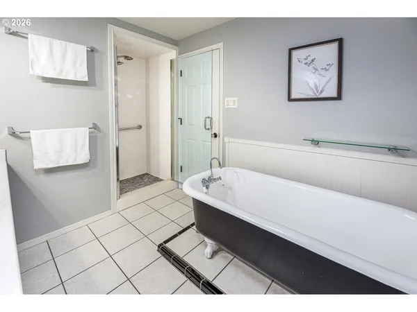 a bathroom with a bathtub and shower