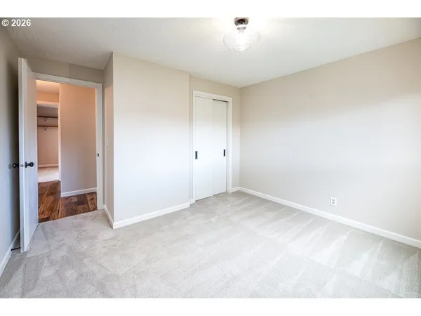 a view of an empty room and closet