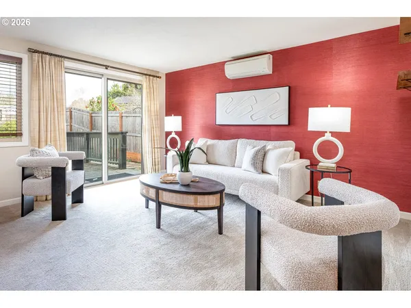 a living room with furniture and a large window