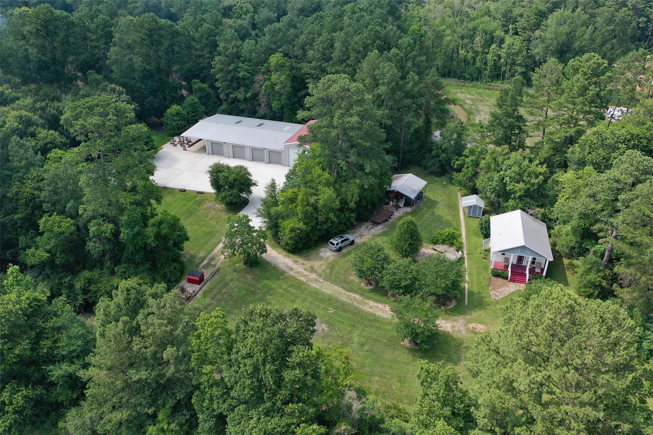 12126 Zion Road Tomball, TX 77375 - Photo 36 of 45 Aerial view of the back of the property with building and guest house. Room to build another home in this area.