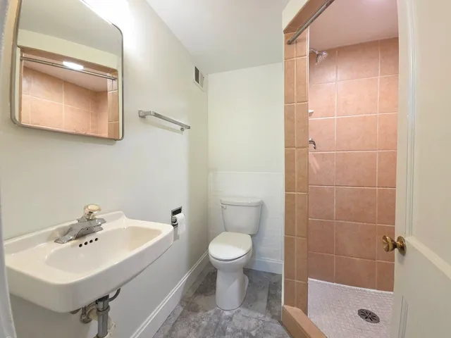 a bathroom with a sink toilet and shower