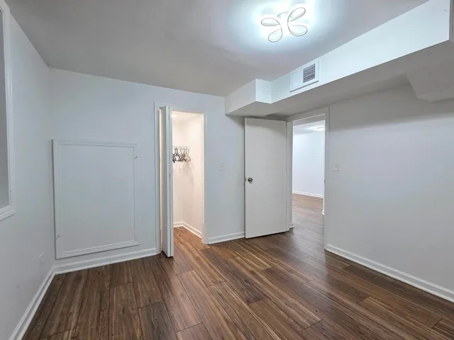 an empty room with wooden floor