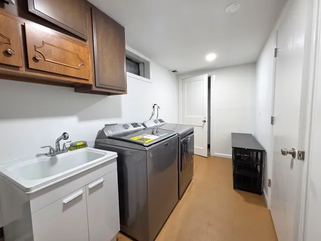 a utility room with sink dryer and washer