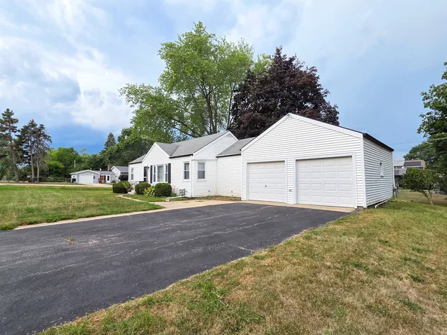 a view of a house with a yard and garage