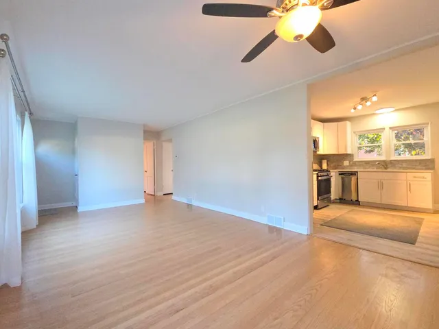 a view of a livingroom with a ceiling fan and window