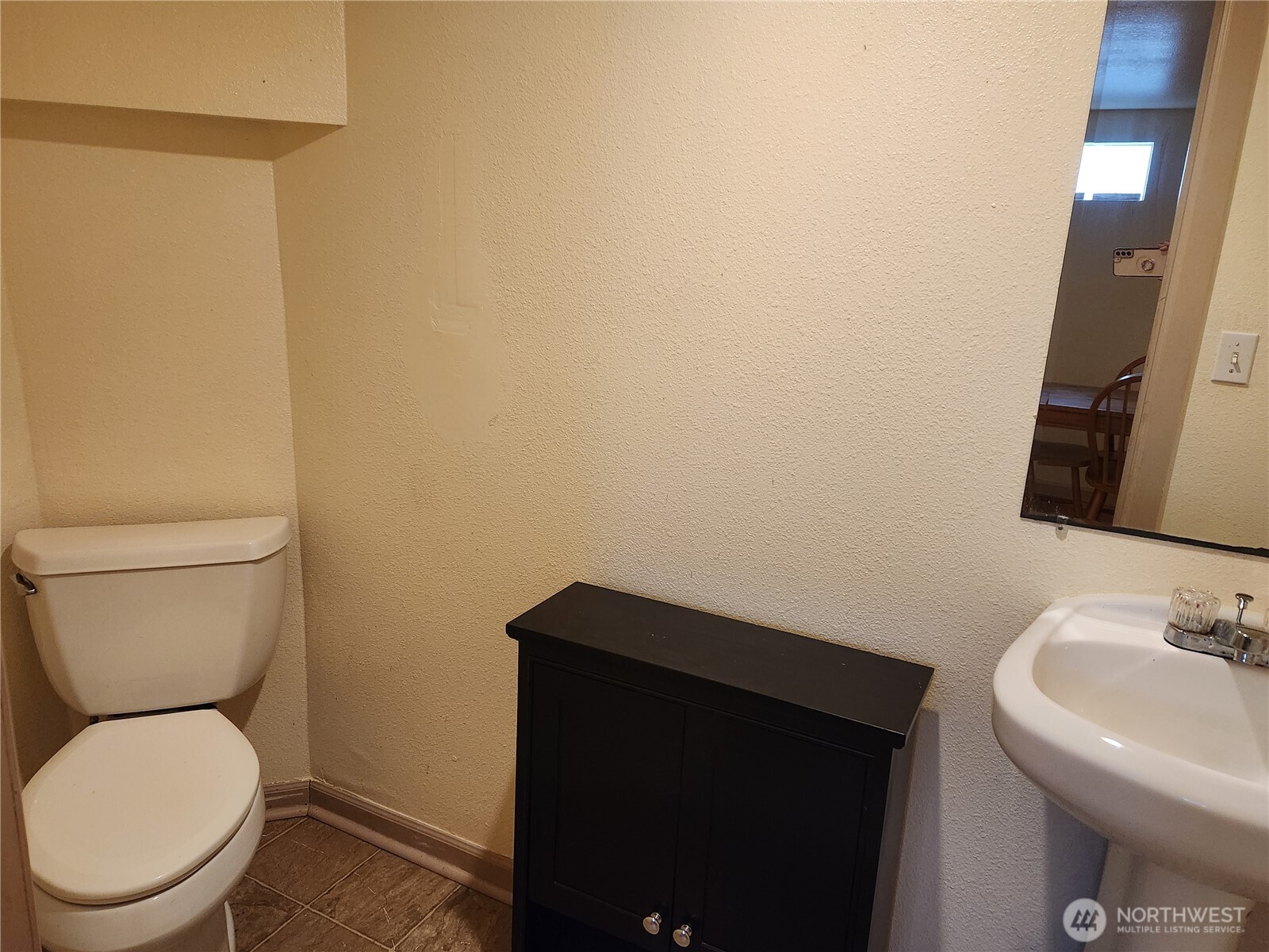 616 South 63rd Street Tacoma, WA 98408 - Photo 14 of 19 a bathroom with a toilet a sink and mirror