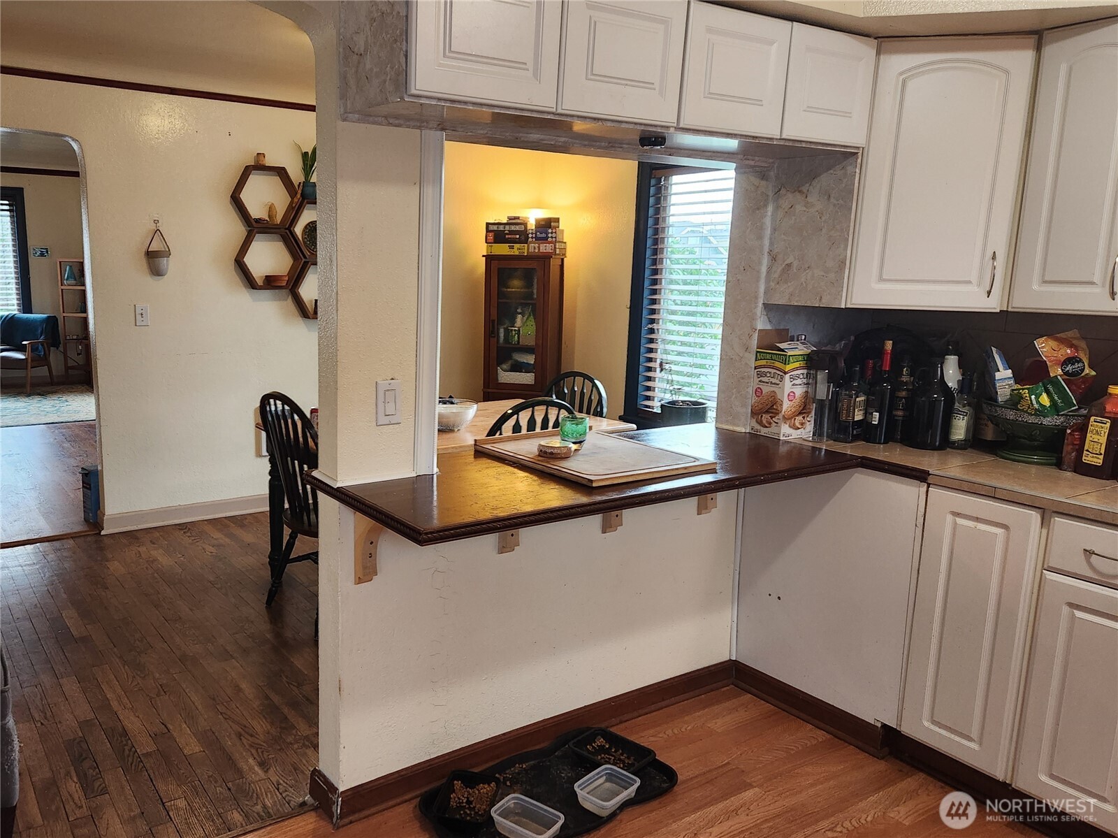 616 South 63rd Street Tacoma, WA 98408 - Photo 7 of 19 a kitchen with stainless steel appliances granite countertop a sink dishwasher a refrigerator and cabinets with wooden floor