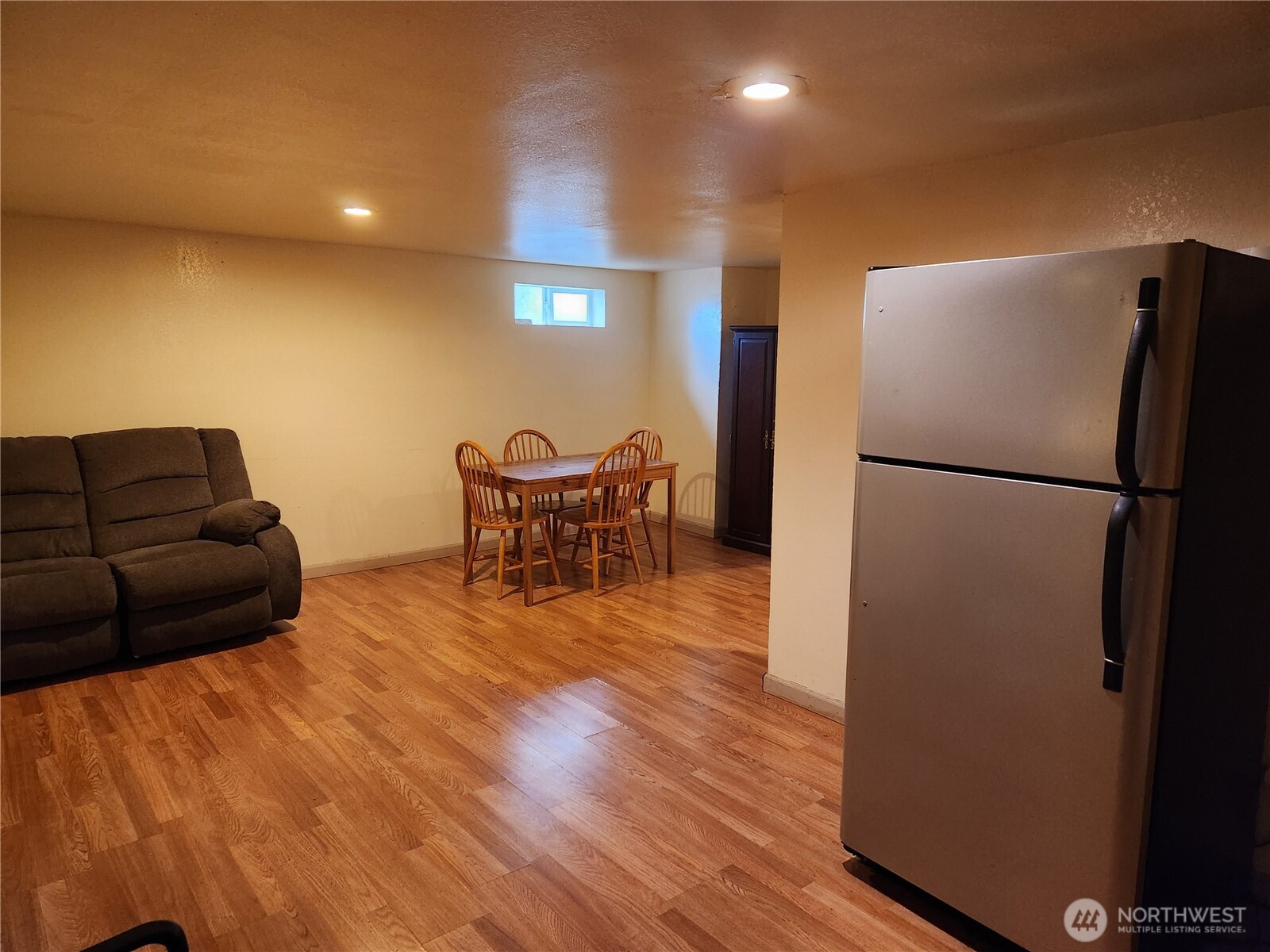 616 South 63rd Street Tacoma, WA 98408 - Photo 10 of 19 a living room with furniture and a refrigerator