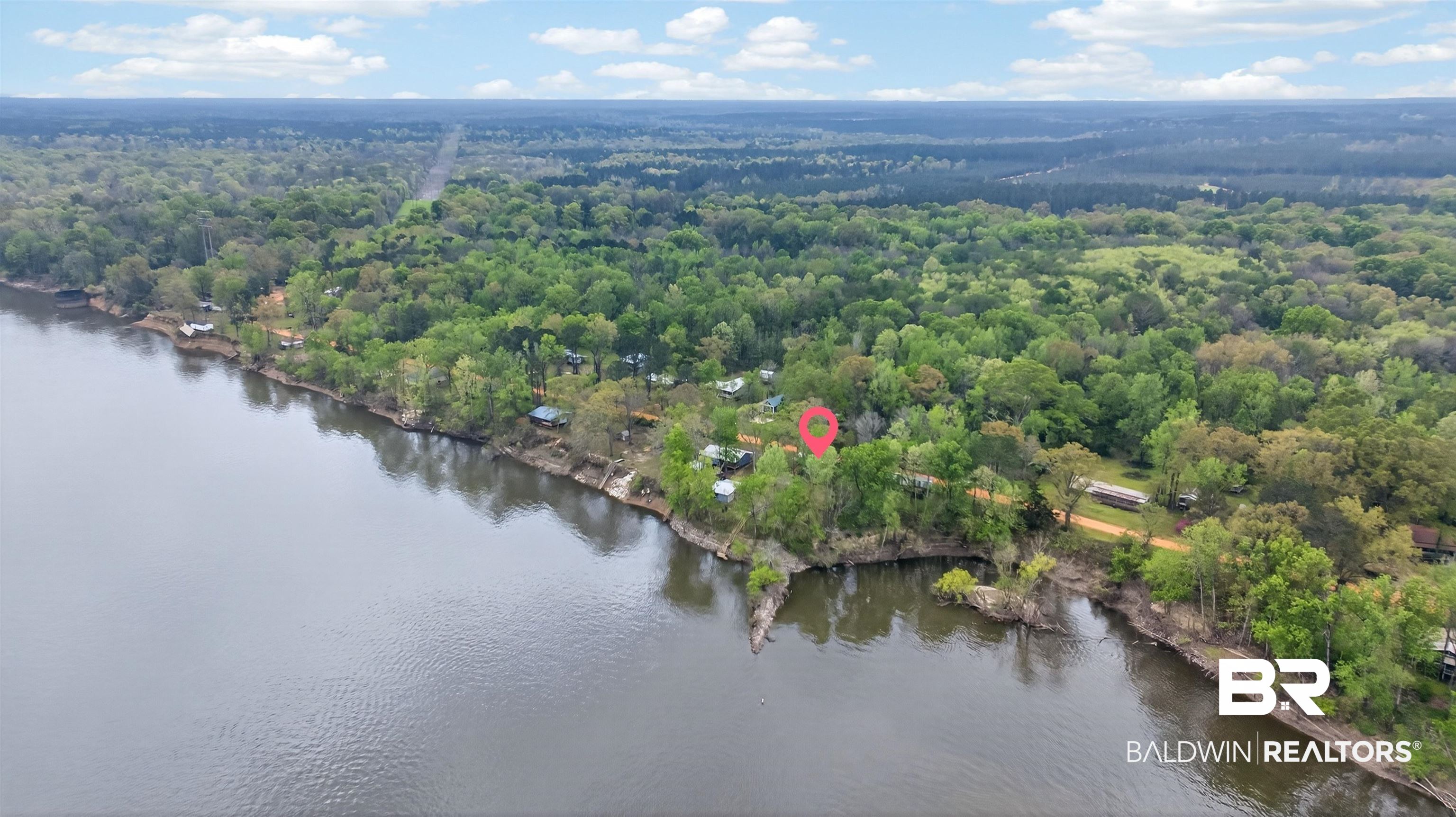 4038 Eureka Landing Road Uriah, AL 36480 - Photo 11 of 25 Aerial view of a nearby body of water and a heavily wooded area