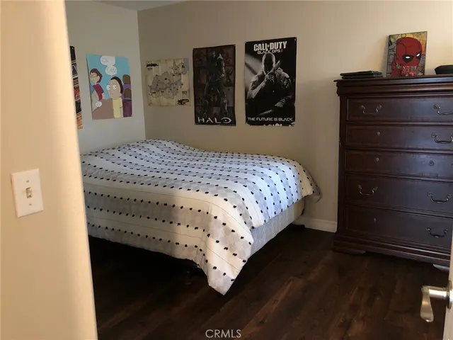 a bedroom with a bed and a dresser
