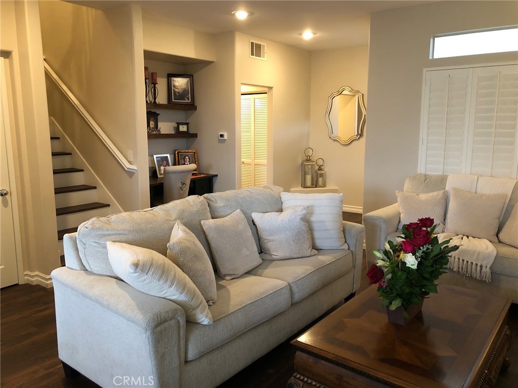 25530 Hemingway Avenue Stevenson Ranch, CA 91381 - Photo 4 of 29 a living room with furniture potted plant and a chandelier