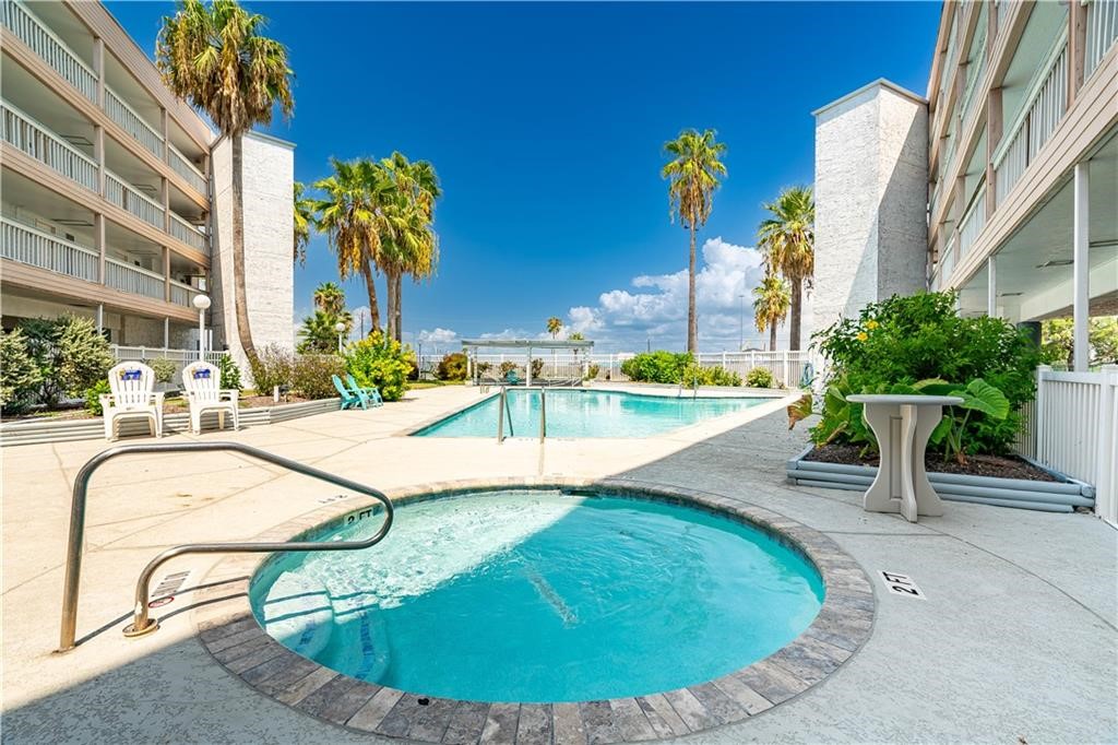 3938 Surfside Boulevard, Unit 3129 Corpus Christi, TX 78402 - Photo 27 of 39 a view of a swimming pool with sitting area