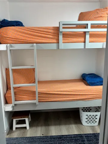 a kitchen with stainless steel appliances granite countertop a table chairs in it and wooden floors