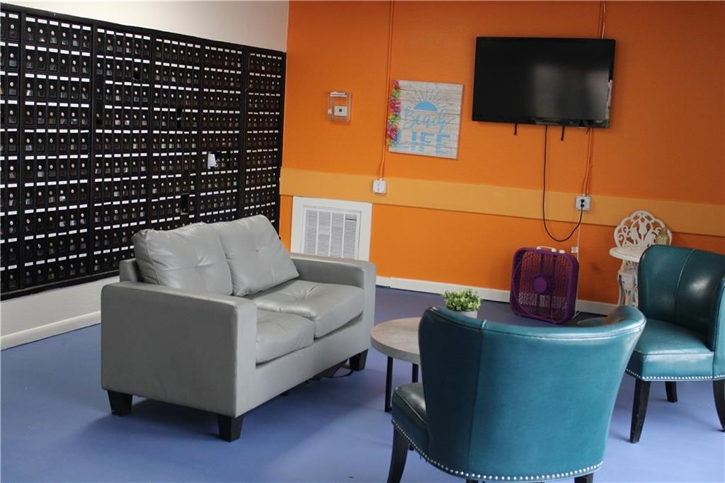 3938 Surfside Boulevard, Unit 3129 Corpus Christi, TX 78402 - Photo 39 of 39 a living room with furniture and a flat screen tv