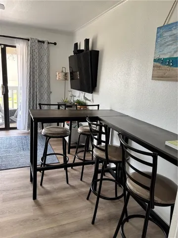 a view of a workspace with furniture and window