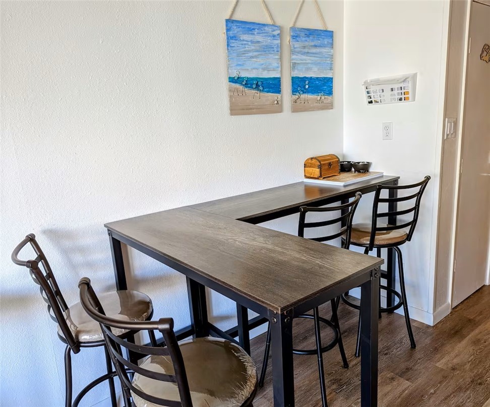 3938 Surfside Boulevard, Unit 3129 Corpus Christi, TX 78402 - Photo 6 of 39 a view of a dining room with furniture and wooden floor