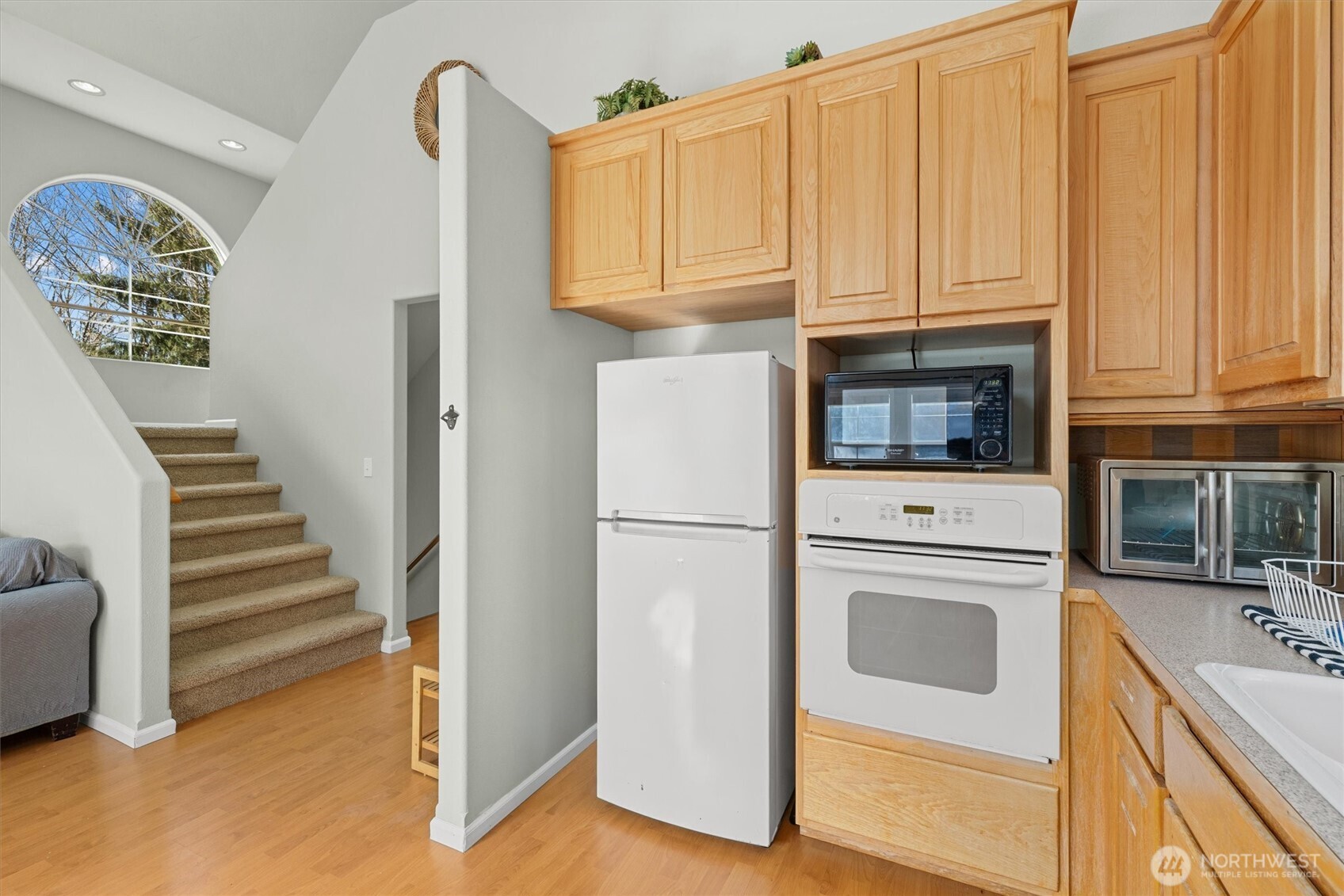 481 Maple Grove Road Port Angeles, WA 98363 - Photo 9 of 40 a kitchen with white cabinets and white appliances