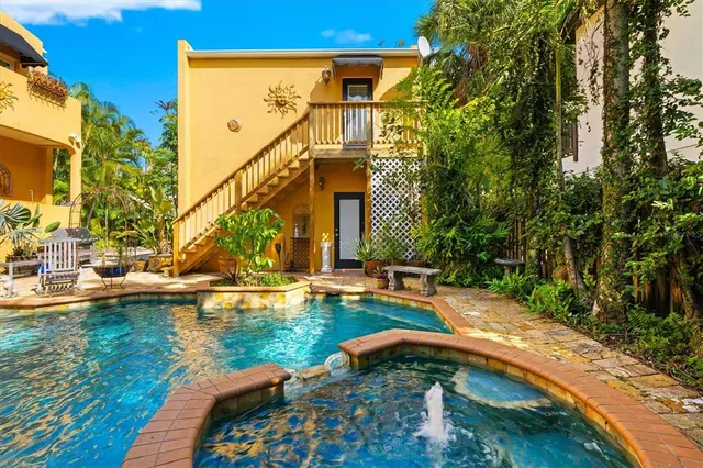 a view of a house with swimming pool and sitting area