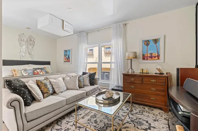 a view of swimming pool with lawn chairs and plants