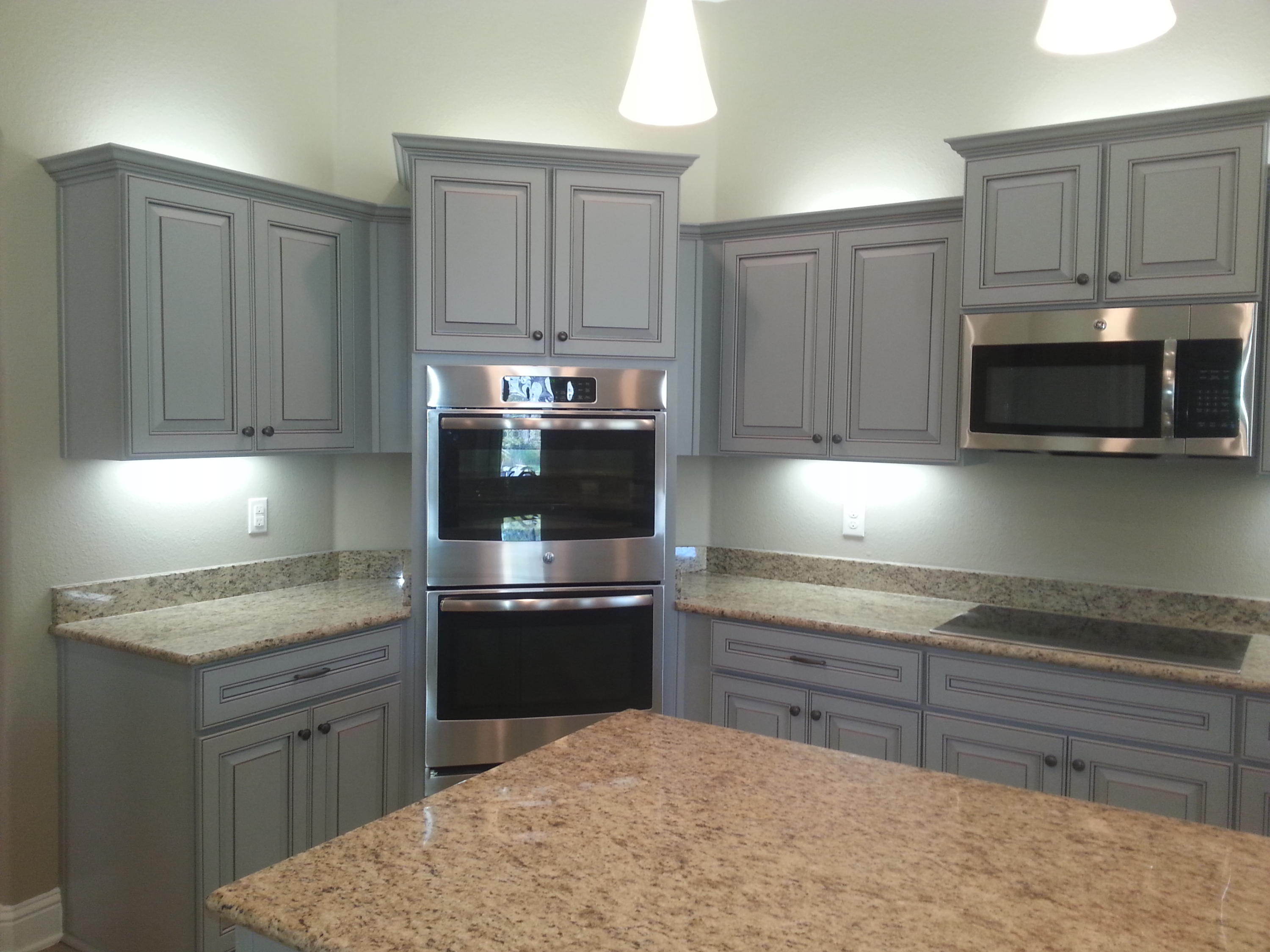 2442 Cove Road Navarre, FL 32566 - Photo 13 of 23 a kitchen with stainless steel appliances granite countertop a stove a sink and a microwave