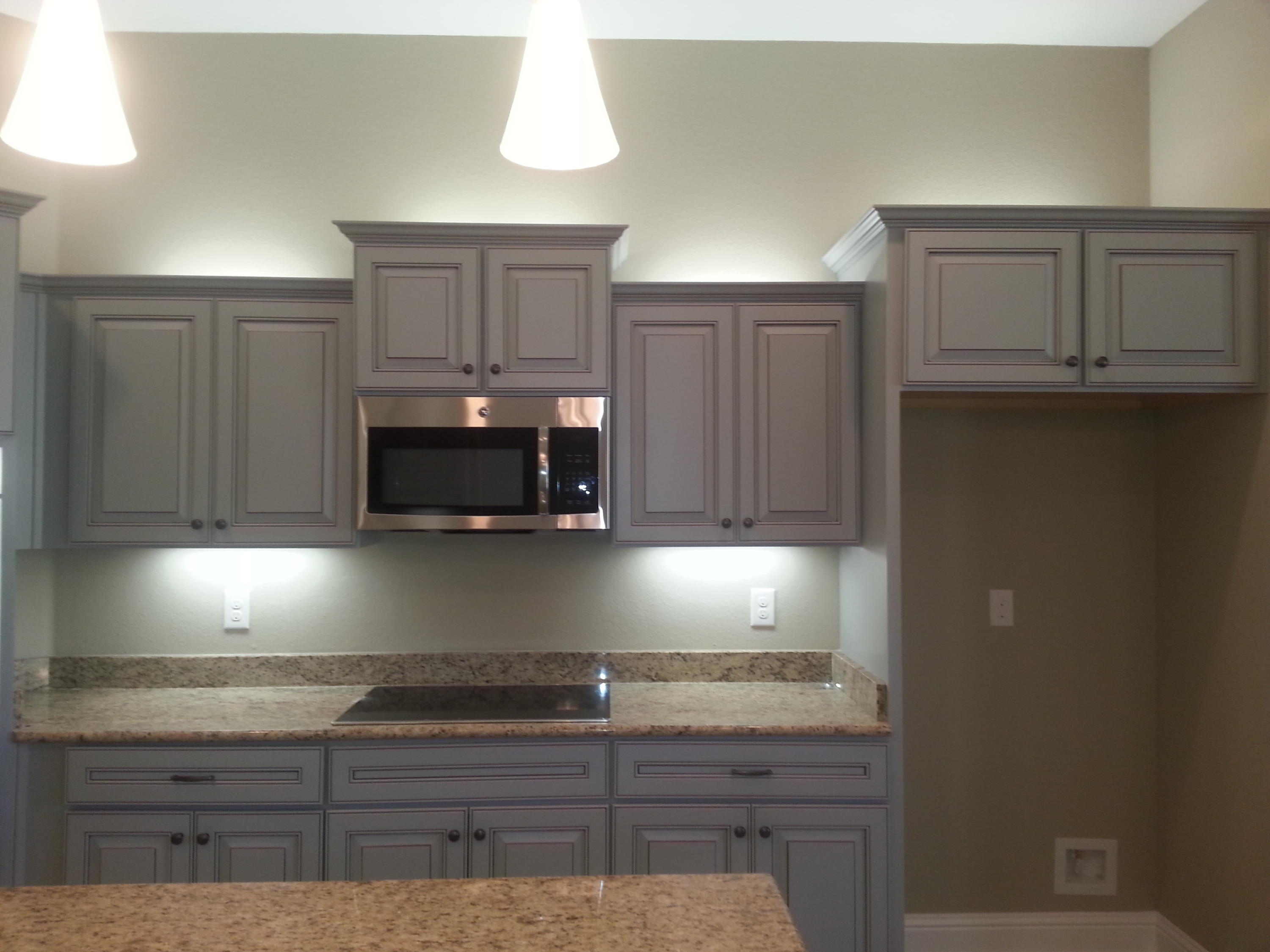 2442 Cove Road Navarre, FL 32566 - Photo 14 of 23 a kitchen with granite countertop a stove and cabinets